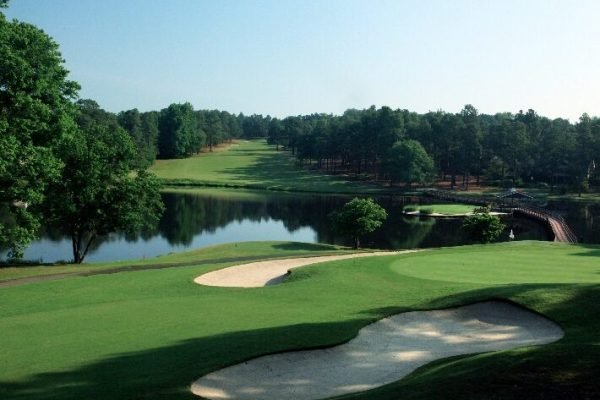 Golfer teeing off at Pinehurst Resort, minutes away from Vacation Pines lodging.