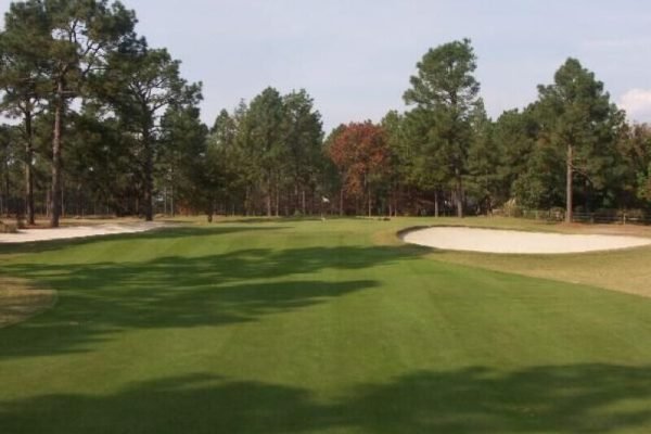 Golfer teeing off at Pinehurst Resort, minutes away from Vacation Pines lodging.