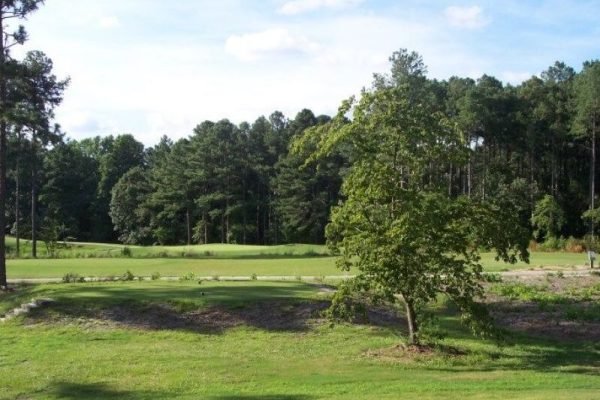 Golfer teeing off at Pinehurst Resort, minutes away from Vacation Pines lodging.