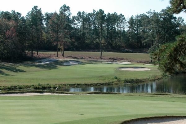 Golfer teeing off at Pinehurst Resort, minutes away from Vacation Pines lodging.