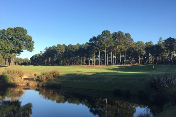 Golfer teeing off at Pinehurst Resort, minutes away from Vacation Pines lodging.